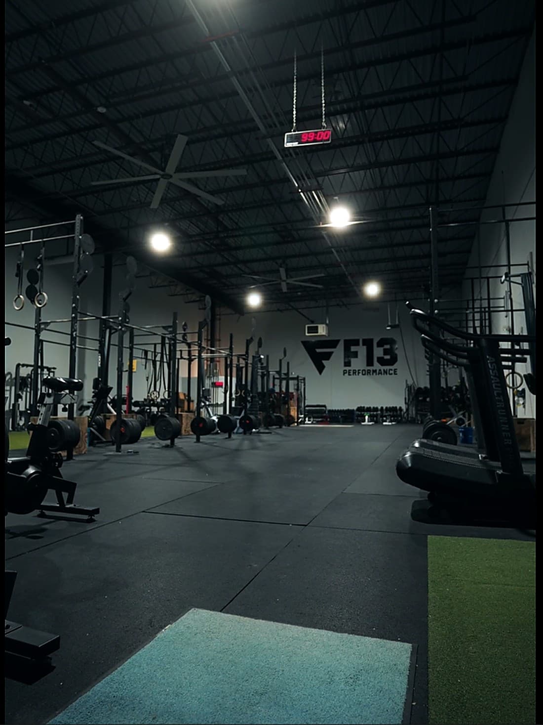 F13 Performance Center showing the turf training area, squat racks, conditioning equipment, and the F13 Performance wall logo at Resistance Strength Allentown